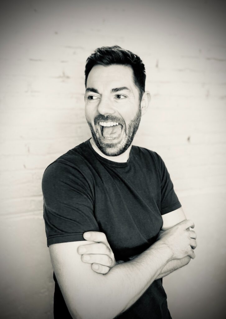 Iain Anderson smiles in black and white headshot