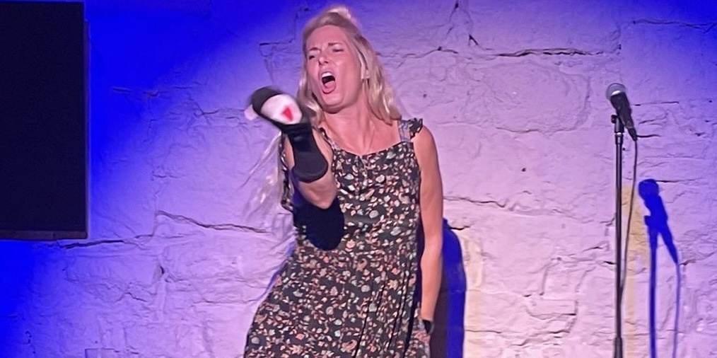 Michelle Ahern sings onstage in Barcelona with sock puppets